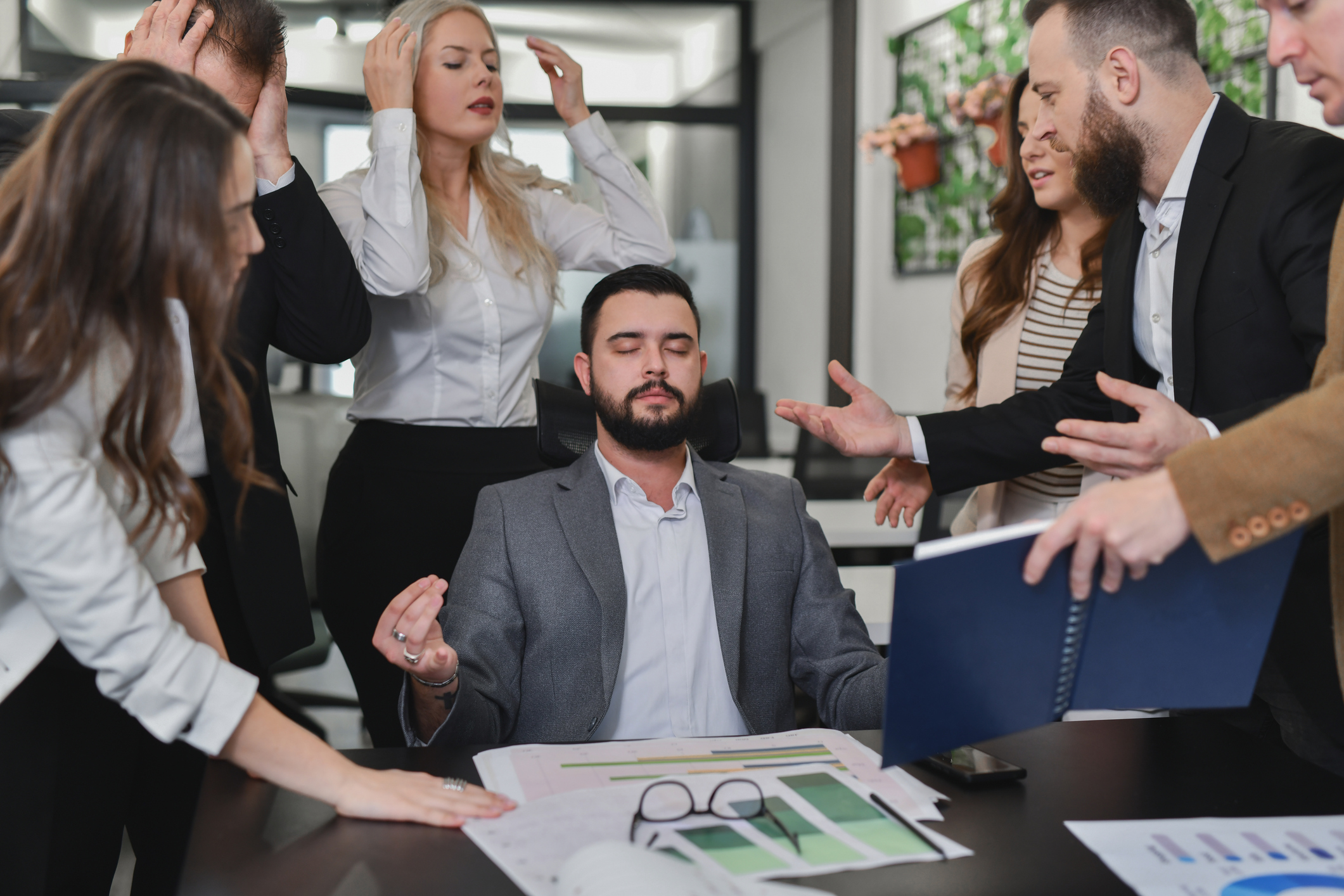 Frustrated Employees Looking For Answers From Manager While He's Meditating With Closed Eyes