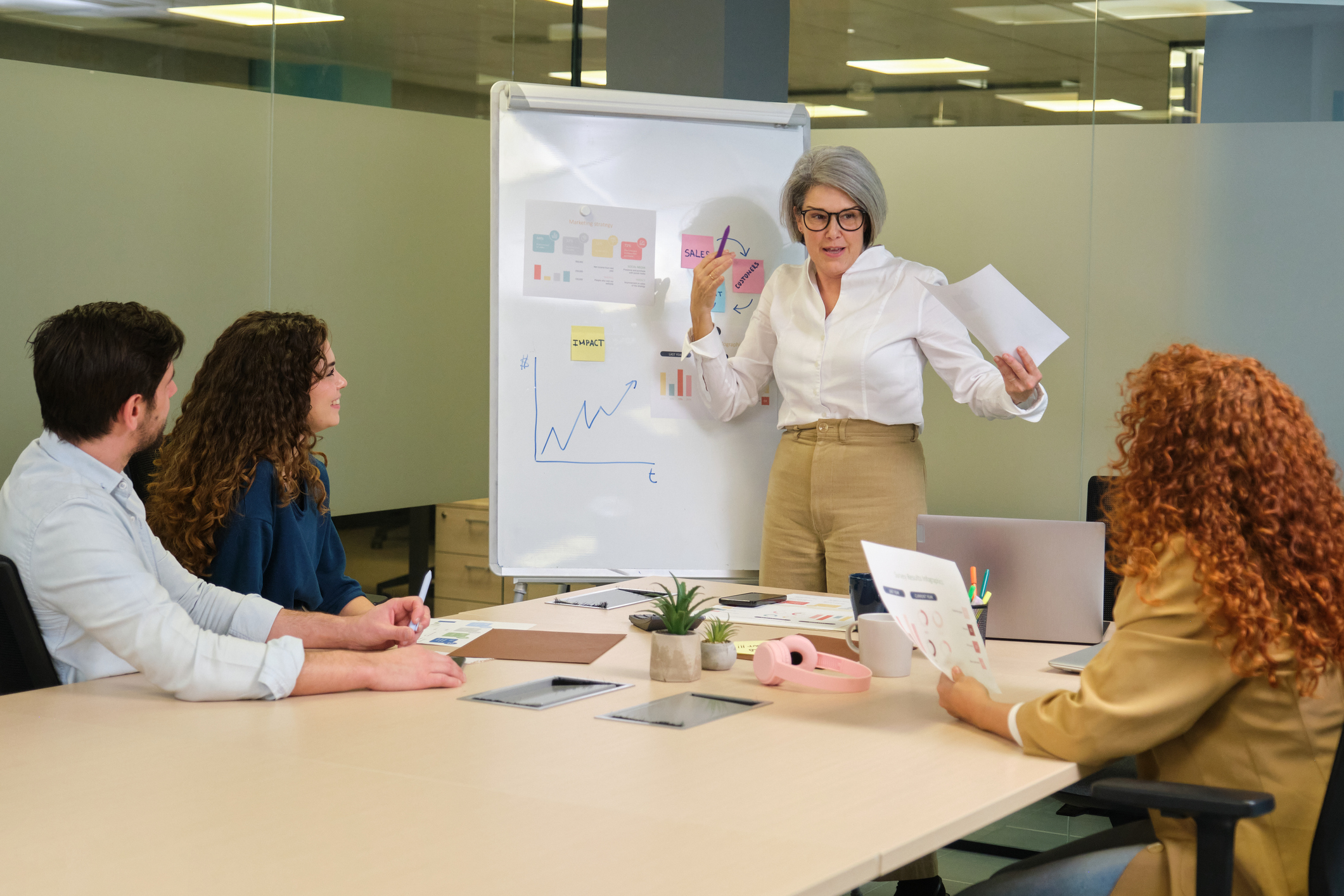 Senior businesswoman leading a presentation to her team in the office