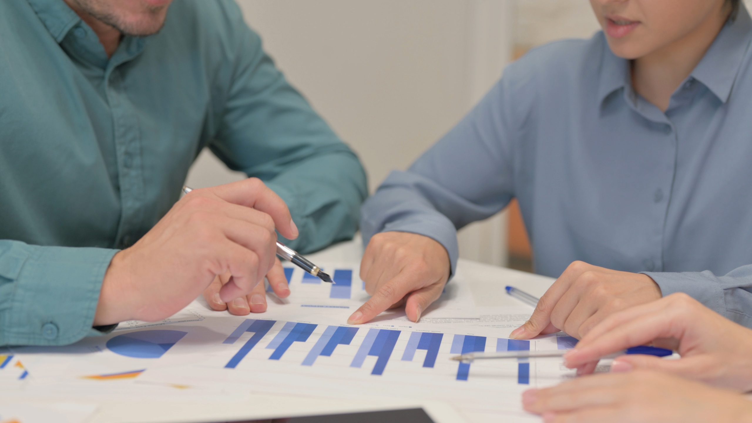 Hands of Teammates Doing Paperwork in Office