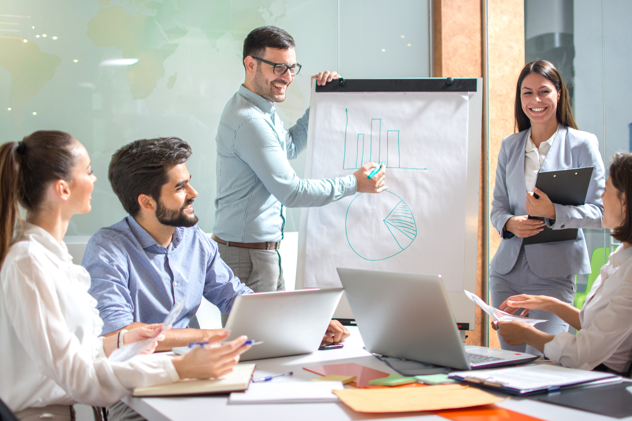 Business people in office meeting with flip chart. Businesspeople, team, training conference concept.