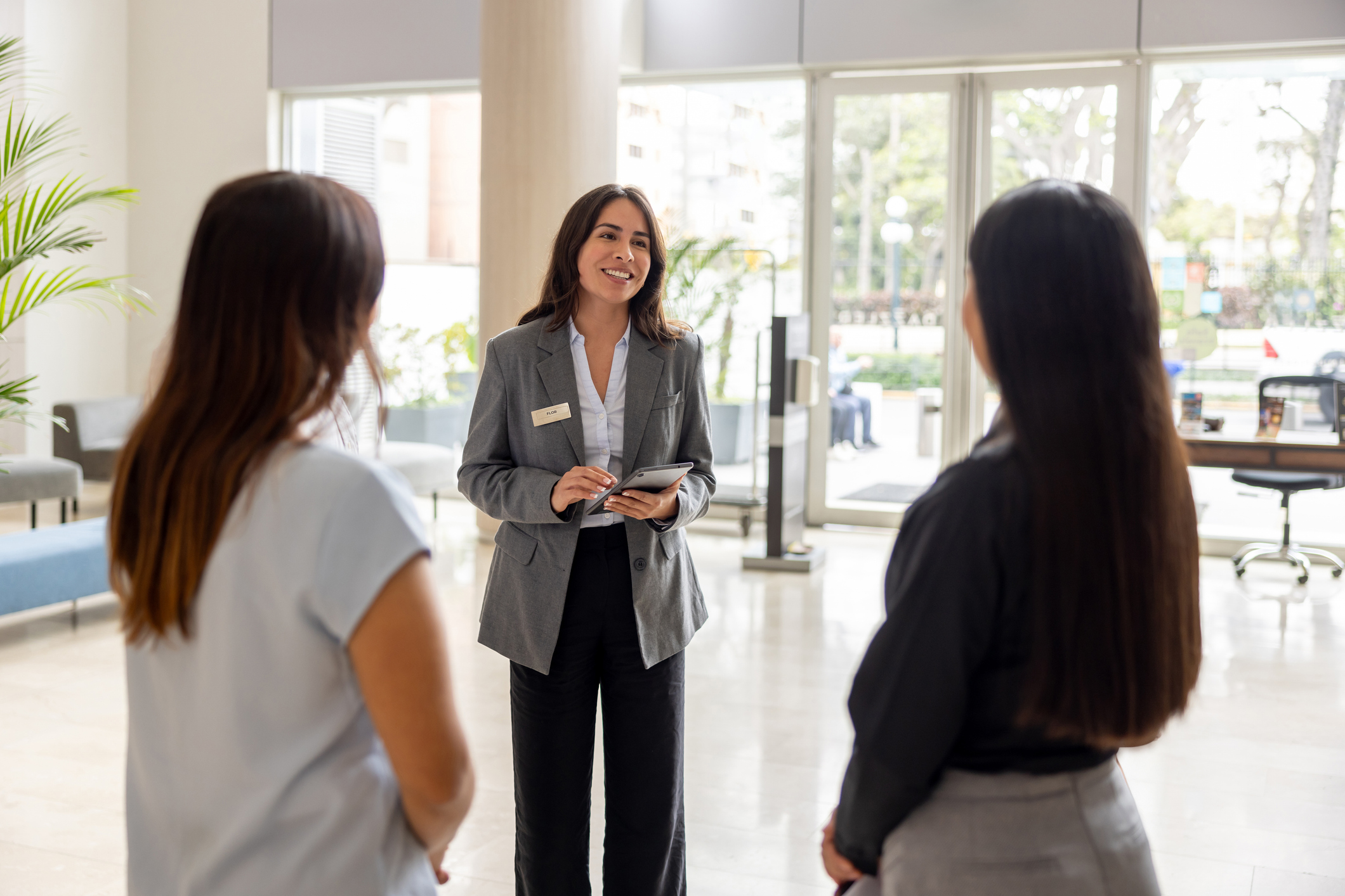 Hotel manager talking to a couple of employees at the lobby